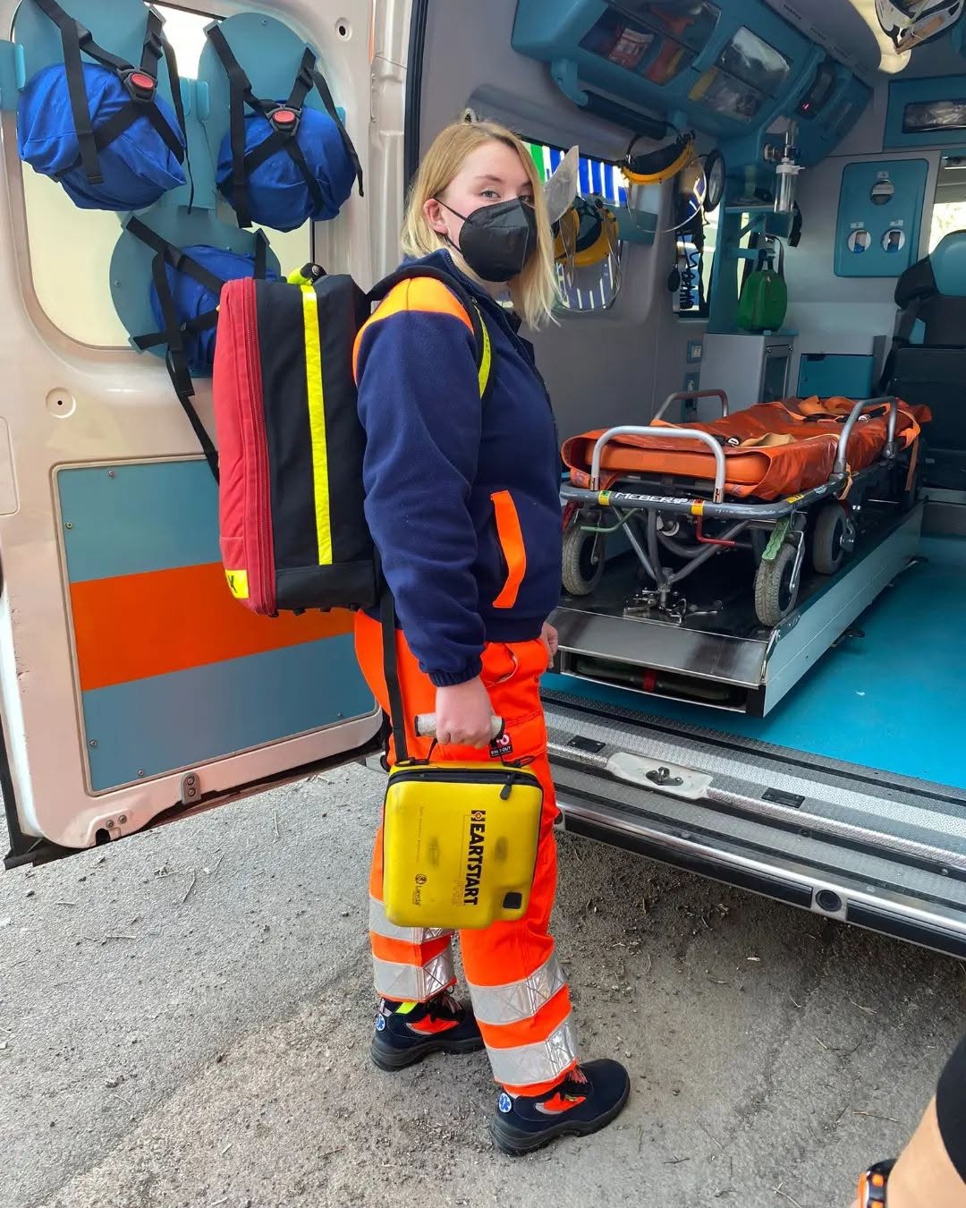 Rescue volunteer with equipment inside an ambulance